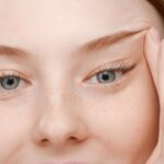 female skin care model lifts her eyes